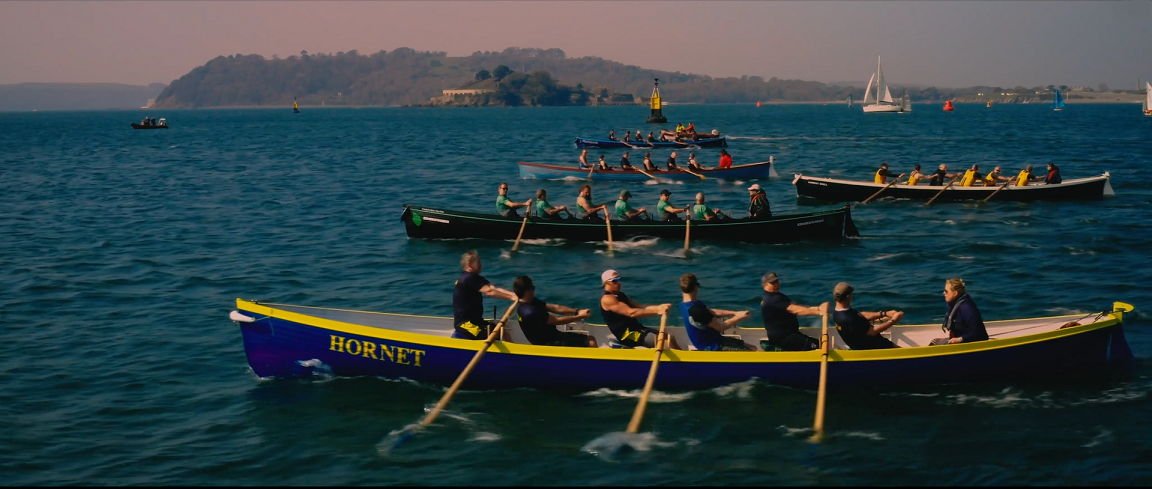 The Yealm rowing club racing their new boat Hornet - bought by the community fund