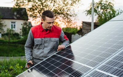 Man installing solar panels. An electrician or engineer works with solar panels. The future of alternative energy and sustainable energy.