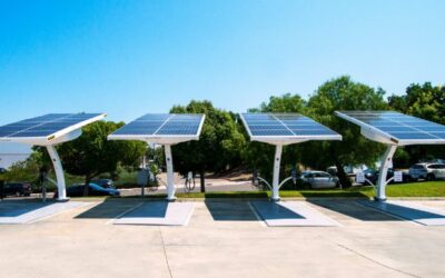A line of solar powered EV chargers under a bright blue sky