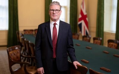 UK prime minister Kier Starmer stands in a conference room facing the camera