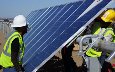 builders in high vis install a solar panel