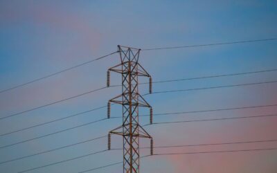 a transmission tower at sunset