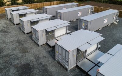 Battery energy storage units in rows on grey ground