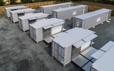 Battery energy storage units in rows on grey ground